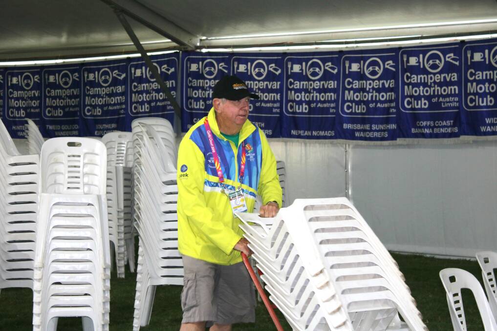 A volunteers helping to set up the marquee for seminars.