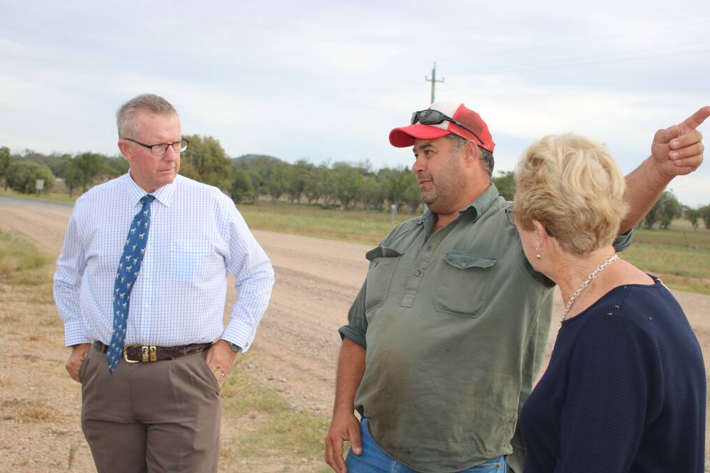 Parkes MP Mark Coulton (left) and Gunnedah councillor Gae Swain (right) listen to the concerns of Mulalley farmer Mick Reynolds on the Grain Valley Road in March.