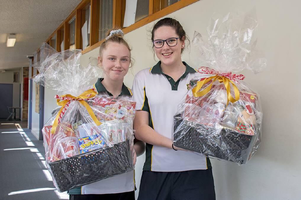 Gunnedah High School's Julia Guest and Maddison Coombs selling raffle tickets for bushfire victims. Photo: Alyssa Barwick