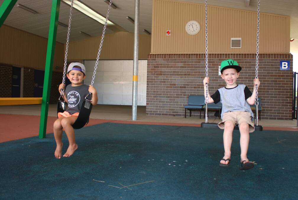 Three-year-old Tiger Leveni and William Ryan have a go on the swings at GS Kidd Memorial School. Photo: Vanessa Höhnke