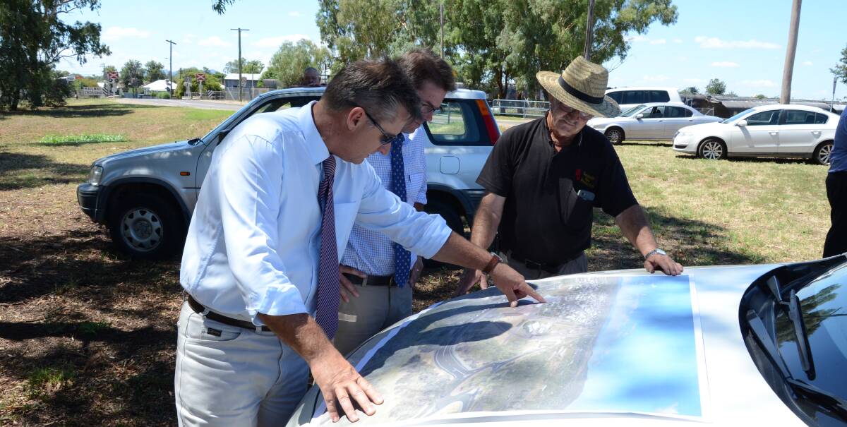 MOVING FORWARD: Gunnedah mayor Jamie Chaffey, Tamworth MP Kevin Anderson and Gunnedah Fire and Rescues David Moses look over plans for the rail overpass. Photo: Billy Jupp