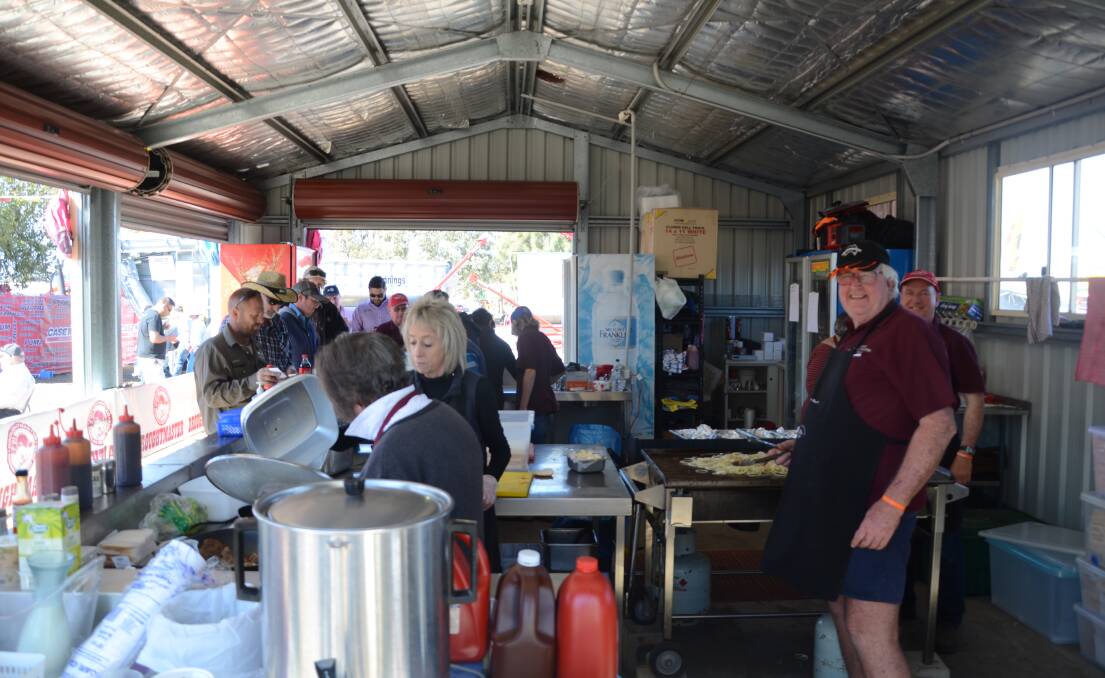 COOKING UP A STORM: The team from Drought Masters get busy cooking on day one of AgQuip. Photo: Billy Jupp 