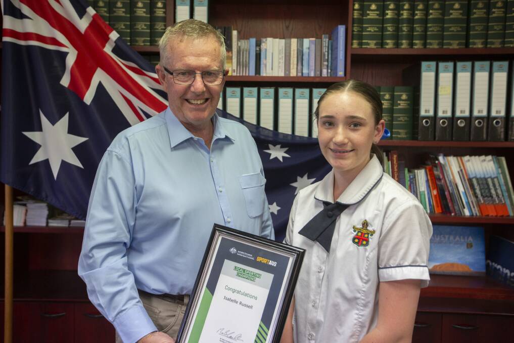 HELPING HAND: Parkes MP Mark Coulton presents one of 20 local sporting champions grants to Dubbo's Isabel Russel. Photo: Supplied 