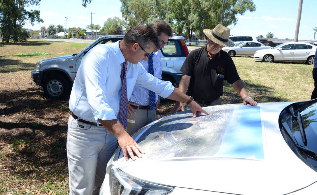 MOVING AHEAD: Gunnedah mayor Jamie Chaffey, Tamworth MP Kevin Anderson and councillor David Moses look over the plans for Gunnedah's new rail overpass. Photo: Billy Jupp 
