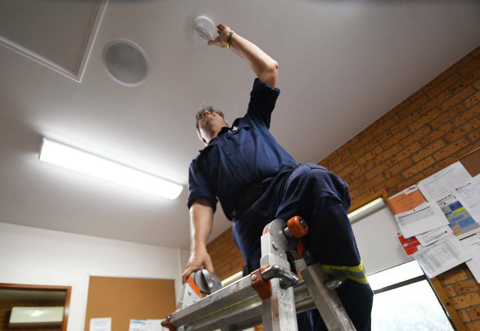 CHANGING TIME: Fire and Rescue NSW senior fire fighter Andrew Coe has seen a considerable reduction in house fires since the smoke alarm awareness campaign was ramped up over the past decade. Photo: Gareth Gardner