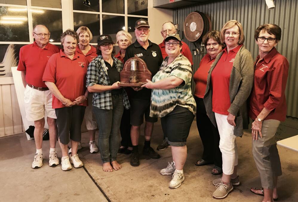 ALL FOR A GOOD CAUSE: The team of Robyn Styles, John Ceissman and Kylie Short from Tambar Springs SES are presented with the miners lantern trophy at the charity bowls day by members of the Gunnedah Volunteer Support Group. Photo: Supplied