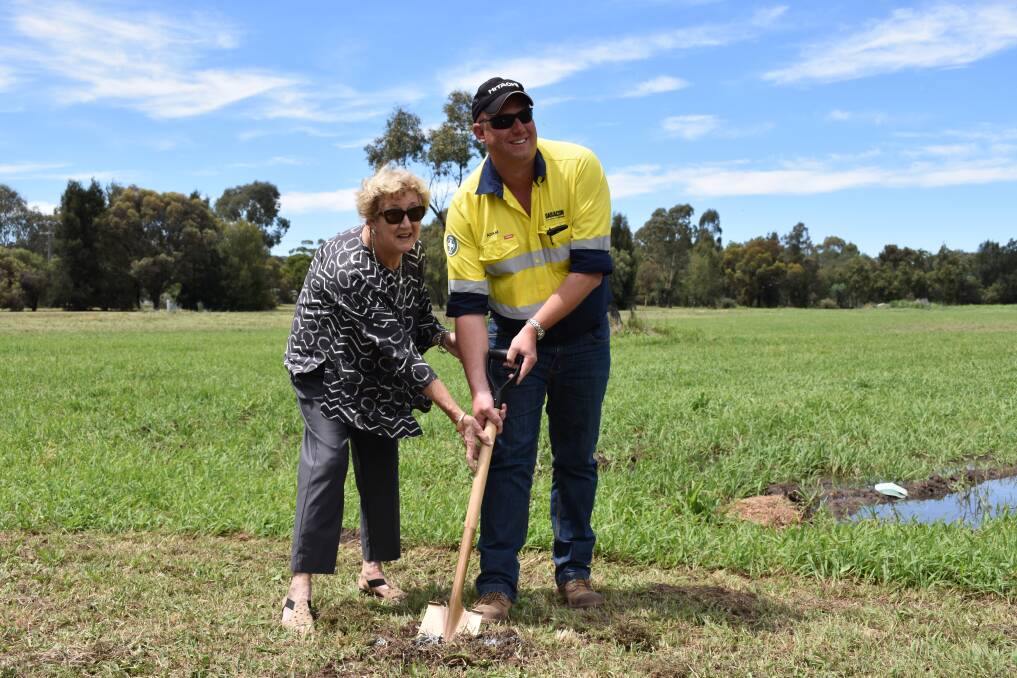 UNDER WAY: Deputy Mayor Gae Swain and Daracon Group’s Construction Manager Adam King turn the sod on the Blackjack Creek Flood Mitigation Project. Photo: Supplied