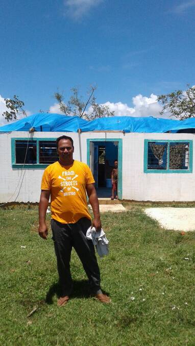 A HELPING HAND: Leslie Pailate in front of his cyclone damaged home in Tonga. Photo: Supplied 