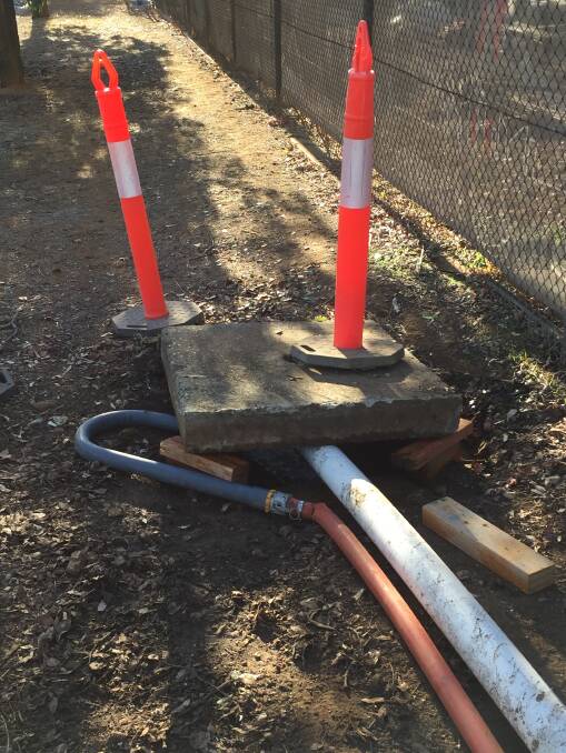 DOWN THE DRAIN: Gunnedah Shire Council began pumping testing water from the Gunnedah pool into a storm water drain on Wednesday. Photo: Billy Jupp 