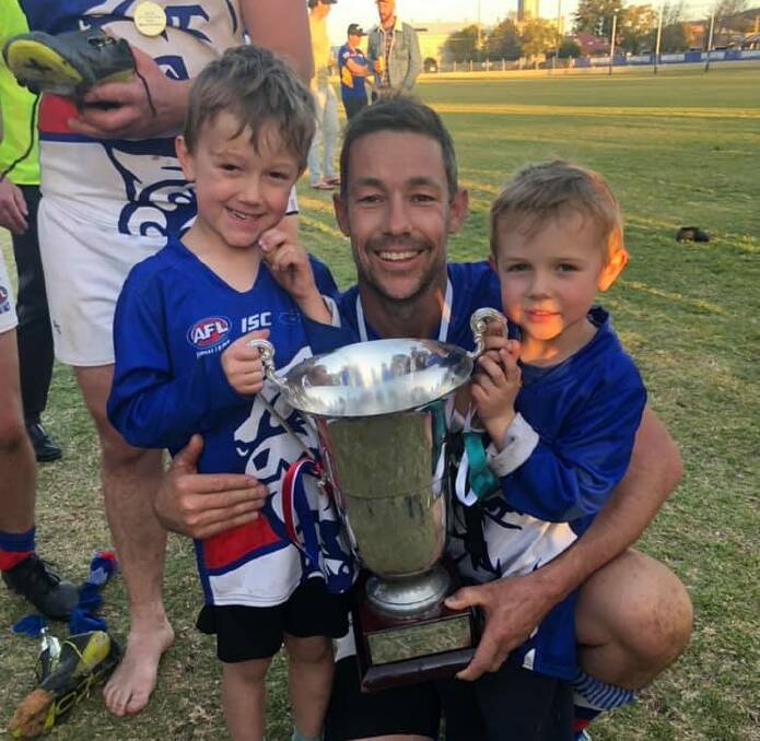 GOING OUT ON A HIGH NOTE: Mark Barrow celebrates the Gunnedah Bulldogs' premiership victory with sons Toby and Jake. Photo: Supplied 
