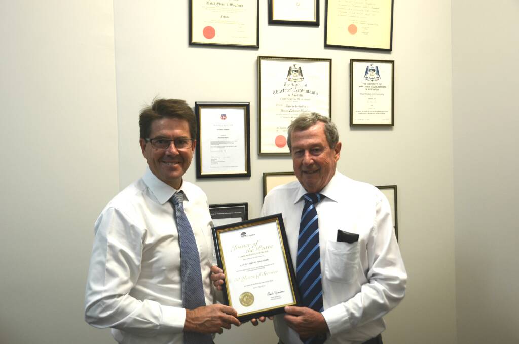 DEDICATION: Tamworth MP Kevin Anderson presents David Waghorn with an award to mark 50 years as a justice of the peace. Photo: Billy Jupp