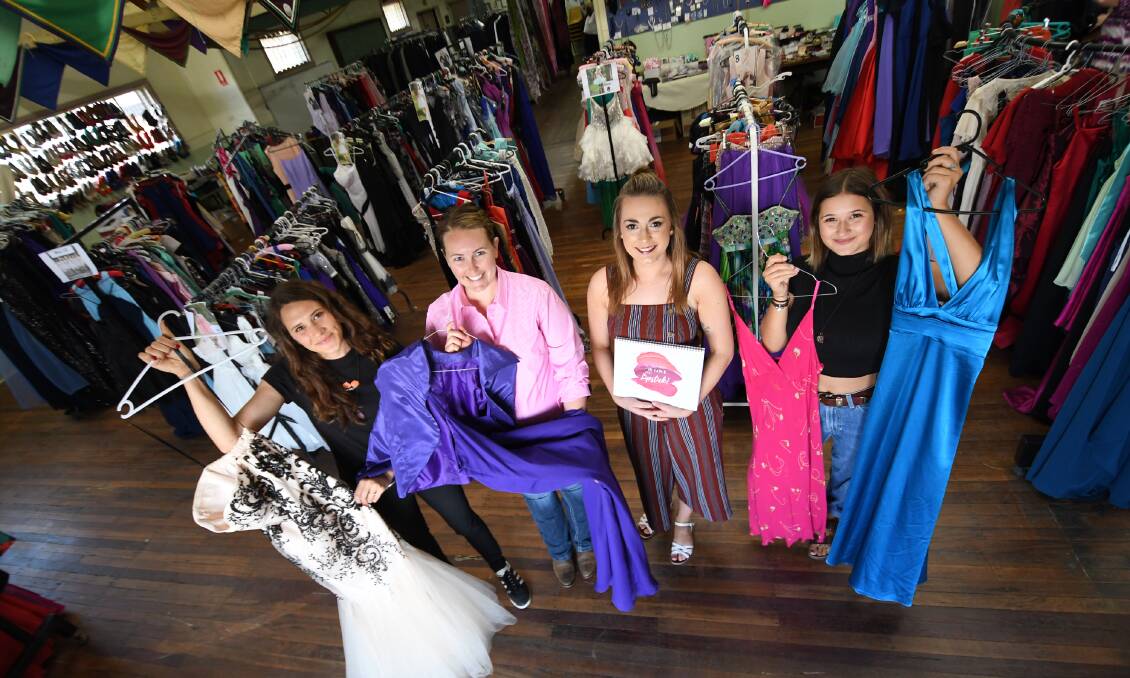 DRESS RELIEF: Lane Sinclair, Amy Sewell, Bridgett Galvin and Saige Sinclair show off some of the donated goods at the Tamworth Scout Hall. Photo: Gareth Gardner 