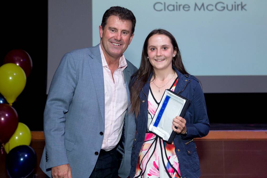 HONOURED: Claire McGuirk receives her award from former Australian cricket captain Mark Taylor. Photo: Supplied 