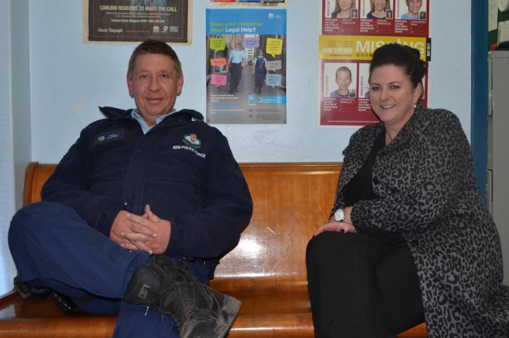 A TRIP DOWN MEMORY LANE: Sergeant Mark Benson joins Jodi Hayne on the same bench she sat on when her father was stationed in Gunnedah between 1977 and 1981. Photo: Billy Jupp 