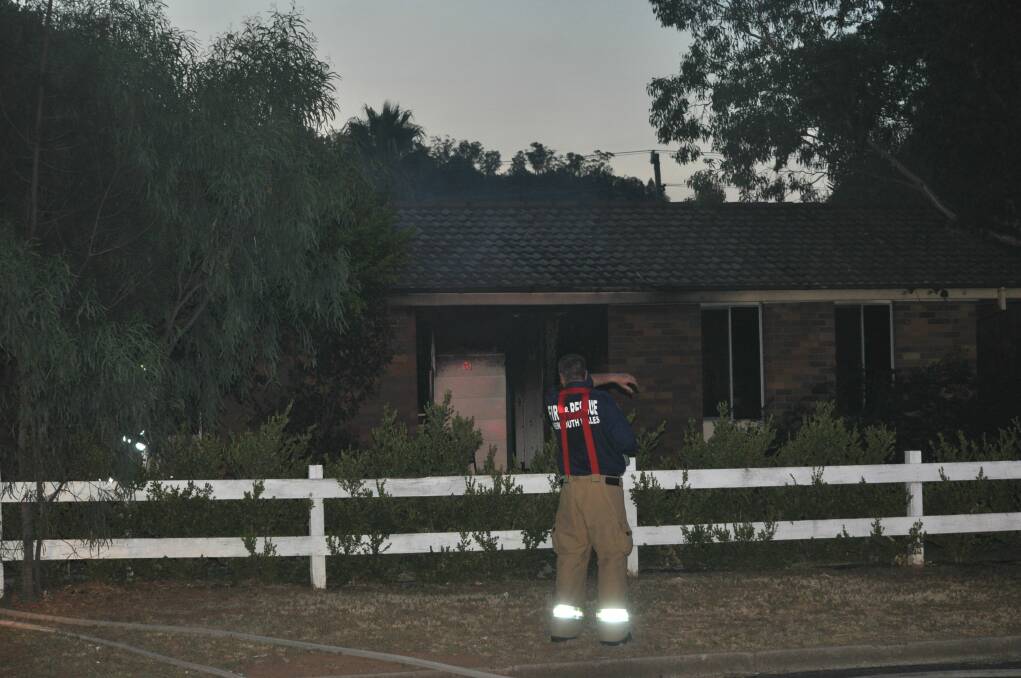 WORKING TOGETHER: Emergency services battle the blaze at the Hopedale Avenue property on Monday night. Since then the community has rallied around the family Photo: Marie Hobson
