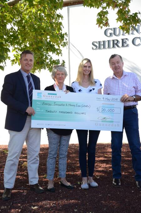 MOVING FORWARD: Gunnedah mayor Jamie Chaffey presents the Gunnedah Show Society's Avard family with a cheque of support for the society's upcoming eIMEx. Photo: Billy Jupp