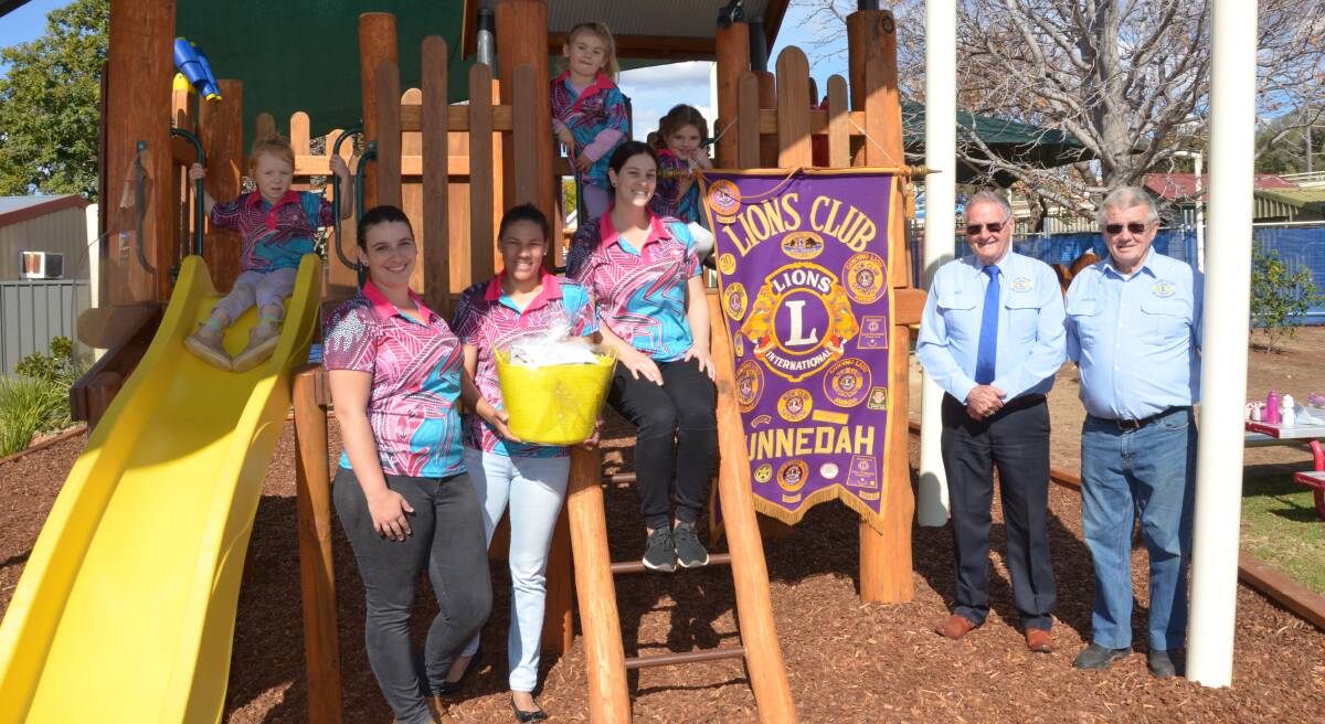 DIGGING DEEP: Gunnedah Pre-School students and staff celebrate the donation of 10 drought relief hampers with Gunnedah Lions Club members Nev Adams and Nev Steele. Photo: Billy Jupp  