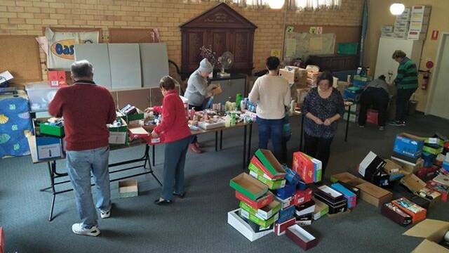 Volunteers sorting the many donations in the original sorting room.