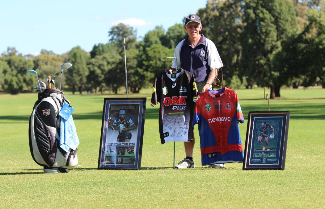 Charitable cause: Men of League north west committee treasurer Peter Haley with some of the memorabilia items to be auctioned at the Gunnedah golf day later this month.