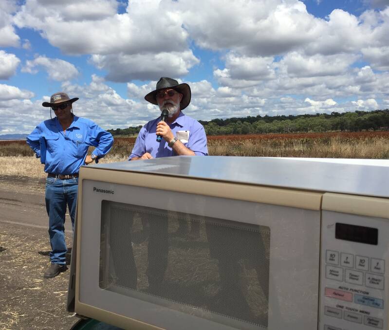 Graham Brodie (right) from University of Melbourne demonstrating the effects of microwave energy on weed plants during last week's field day at Pine Ridge.