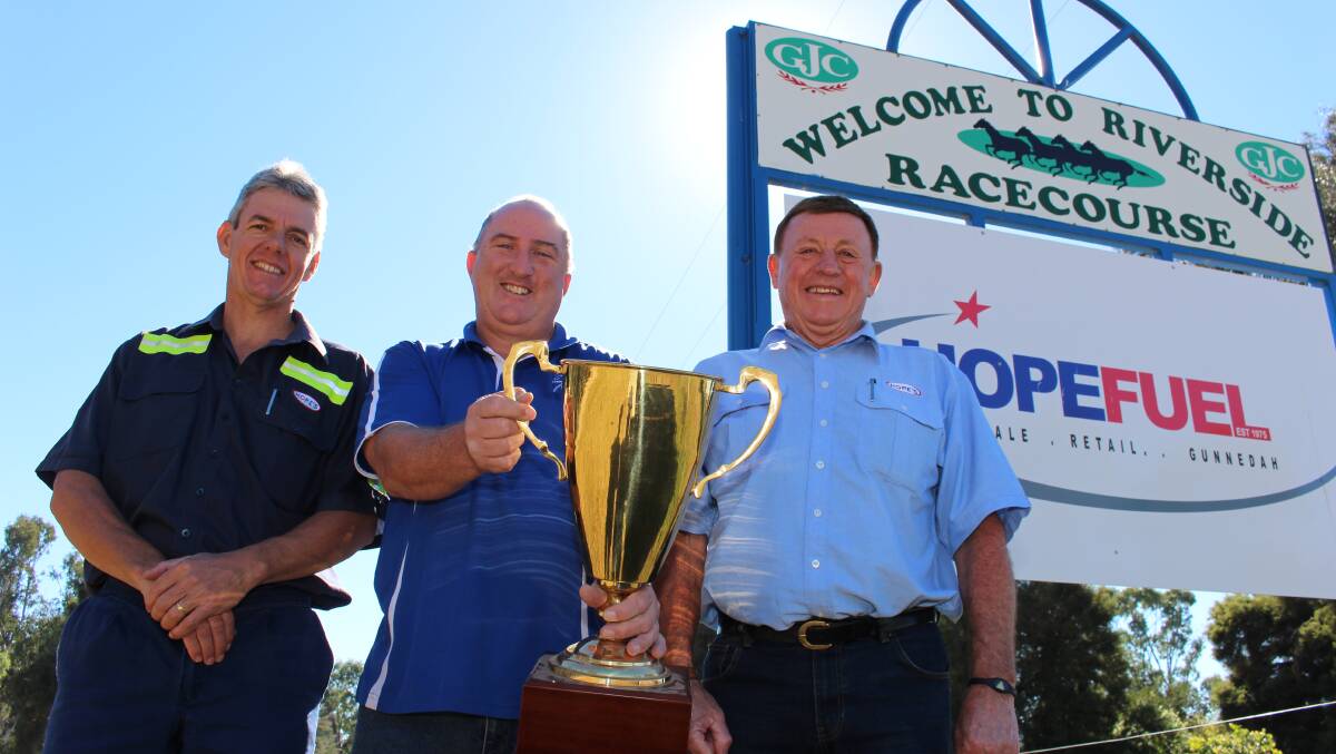 New sponsors: Rod and Paul Hope from Hope Fuel with Gunnedah Jockey Club secretary manager Mark Storey (centre) and the prized Gold Cup. Photo: Sam Woods