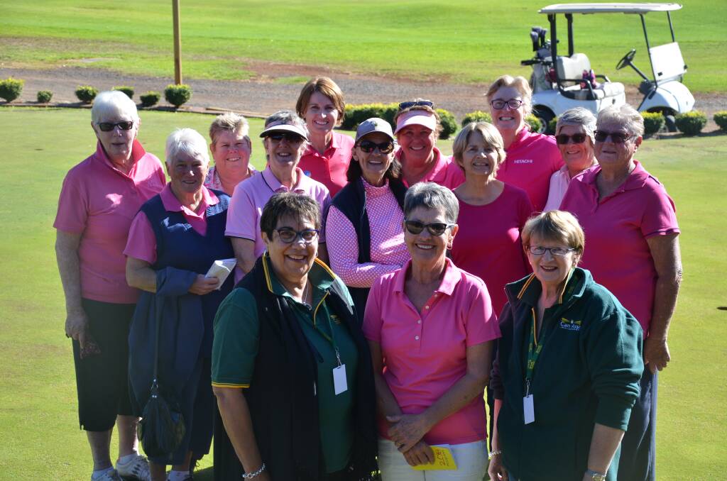 Pinks on the links: Lady Golfers president Coral Lorimer flanked by Can Assist volunteers Kate Knight and Linda Lee with the Lady Golfers on the green for Pink Ribbon day. Photo: Chris Bath