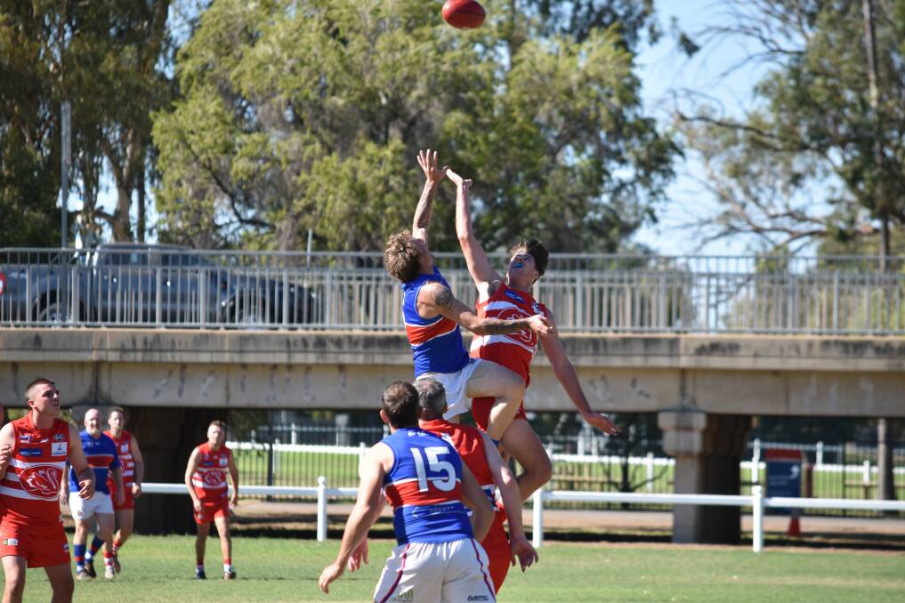 FLYING HIGH: Bulldog Jacob Spackman and Swan Adam Cruickshank compete for a ball-up at the 2019 Crossroads Cup. Photo: Ben Jaffrey