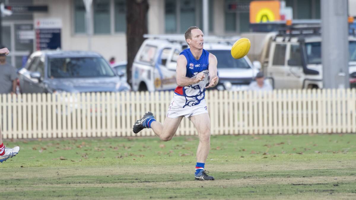 GREAT: Andrew George gets a handball away while playing for the Gunnedah Bulldogs during the 2021 AFL North West season. Photo: Peter Hardin