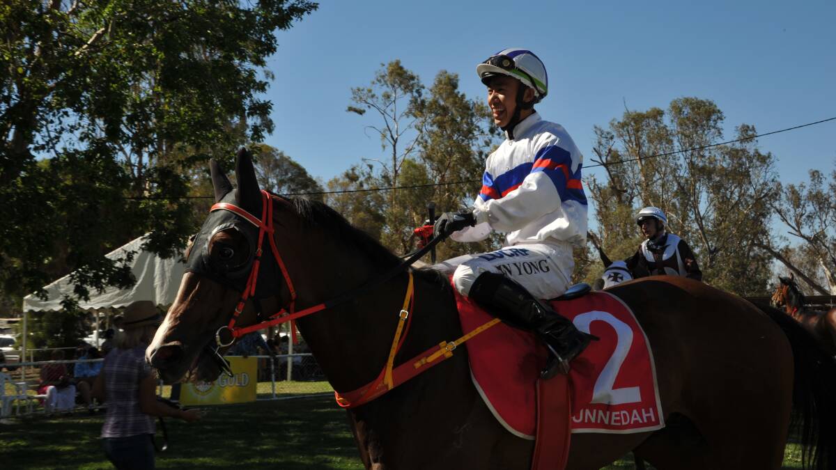 BEAMING: Chinese apprentice Qin Yong after guiding Malzzom to a comfortable win at Gunnedah on Saturday.