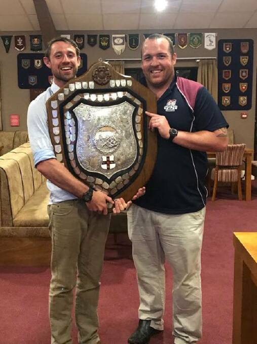 GREAT ADVENTURE: Former Red Devils standout James Perrett and Matty Jones, his skipper at the Scarborough rugby club in North Yorkshire, and the Yorkshire Shield - one of the sport's oldest trophies. Photo: Supplied