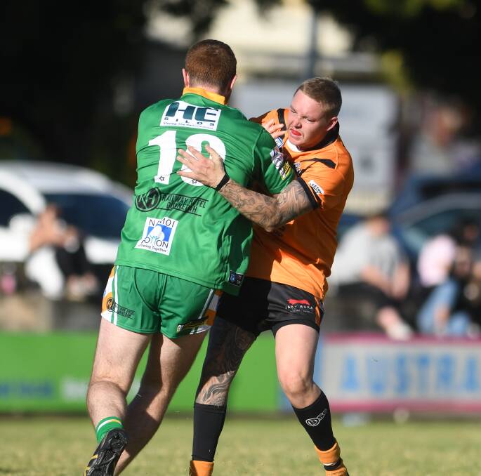CLOSE CONTACT: Tigers No 11 Mitch Turrell and Roos No 10 Nick Lyons get close up and personal.