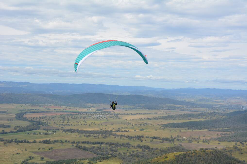 SCENIC: A pilot takes off from Mount Borah on the final day of the paragliding State of Origin on Sunday. 