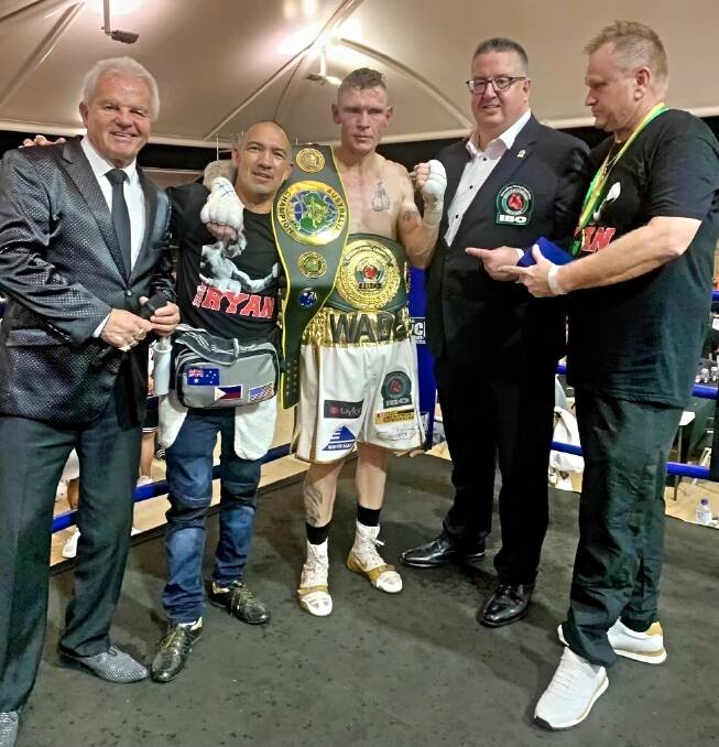 'LONG TIME COMING': Wade Ryan and his trainer, David Syphers (far right), celebrate the Gunnedah fighter's first national title. Photo: Supplied