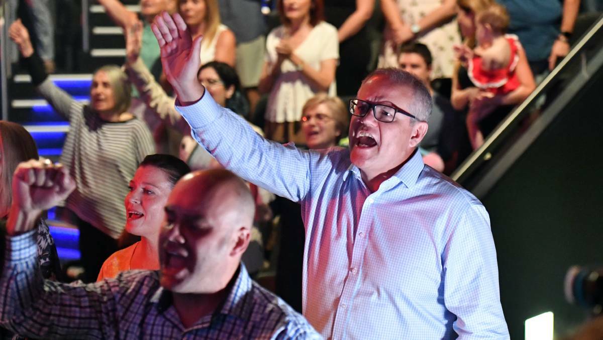 PROFOUND: With his eyes shut and his hands raised and concert lights flashing, Morrison moved at speed - bumping off people like a dodgem car. Photo: AAP