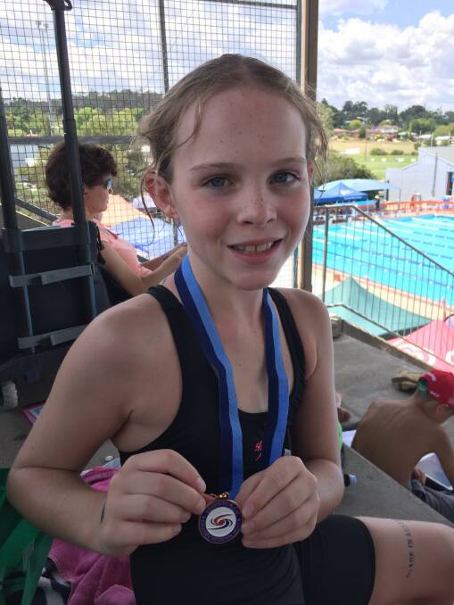 THE MACHINE: Georgia Lyons is all smiles after winning bronze in butterfly at Armidale. Photo: Supplied