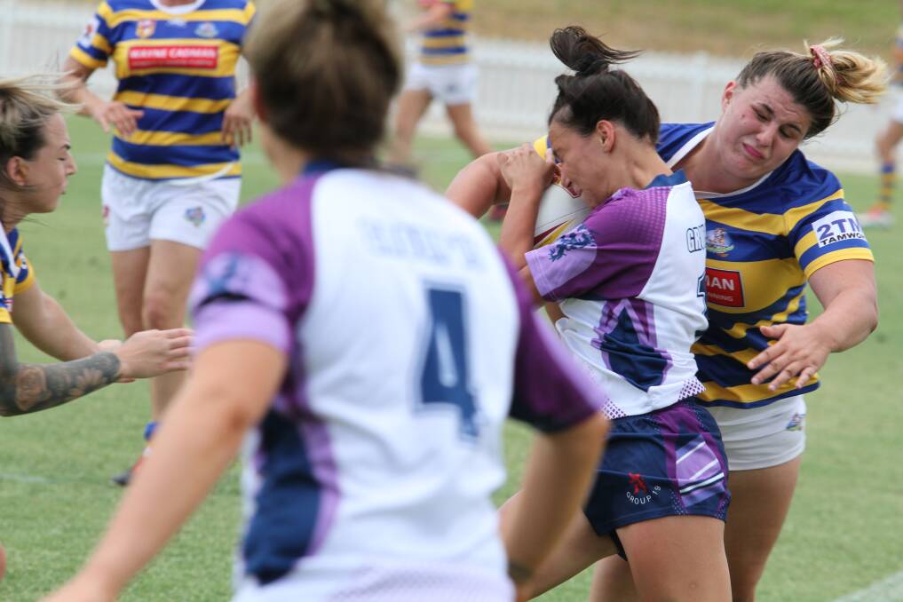 IMMOVABLE OBJECT: Group 4's Cassidy Carter puts a mega hit on Group 19 fullback Taneika Landsborough. Photo: Mark Bode
