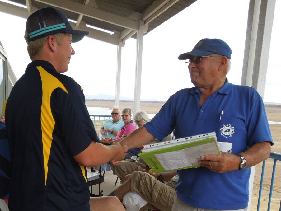 FLEET DREAMS: Tim Caslick, a student from Willowtree, is congratulated by Lake Keepit Sailing Club vice-commodore Ian Pine after winning the Vice-Commodore's Plate (corrected time) last weekend. Photo: Supplied
