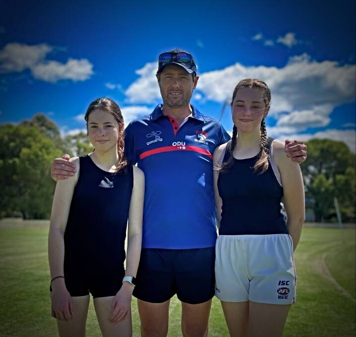 THE CLAN: Jayla, John and Amelia Woolaston at the Bulldogs' come and try day this month. Photo: Mark Bode
