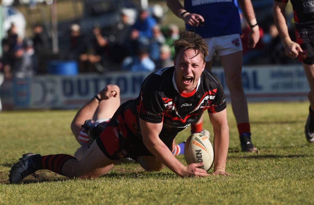 ECSTASY: Bears second-rower James Cooper scores one of his two tries against the Bulldogs. Photo: Gareth Gardner