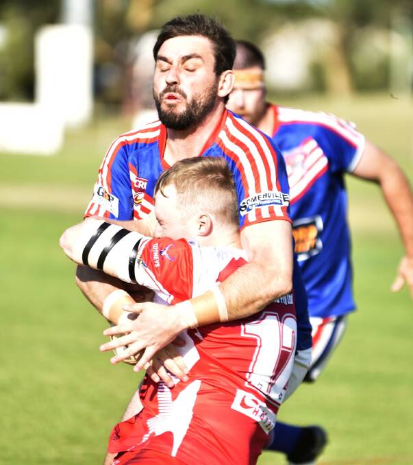 BRICK WALL: Aaron Donnelly comes to grips with Singleton back-rower Jake Mackaway early in the trial at Kitchener Park on Saturday. Photo: Mark Bode