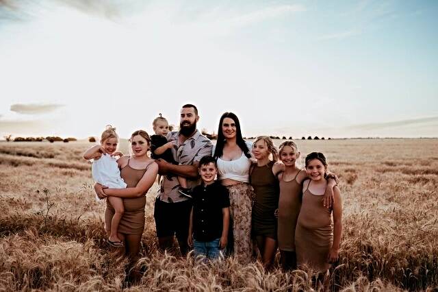 Gallen and his partner, Kristina Syphers, his son, his four stepchildren and two girls that he and Kristina fostered. Picture supplied