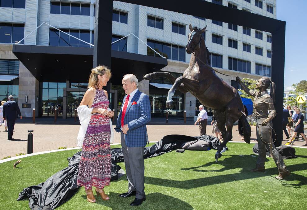 Dark horse: Artist Tanya Bartlett, of Maryland, with racing legend John Tapp at the unveiling of her sculpture, The Yearling and the Leader. 