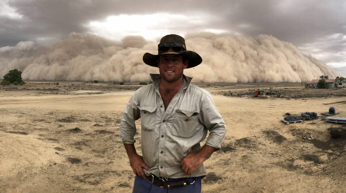 Rob Rogers in front of a huge dust storm descending on the Booligal district. Photo by Jessie Palmer.