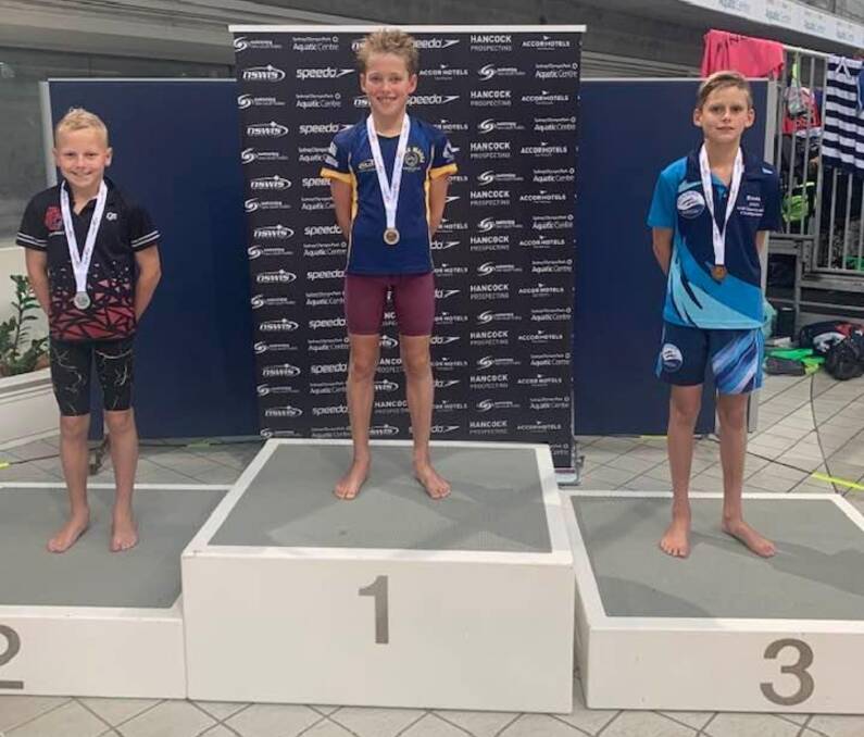 Podium: Baxter Knapman (right) picked up a bronze medal for his efforts in the 50m Breaststroke. Photo: John Hickey Facebook. 