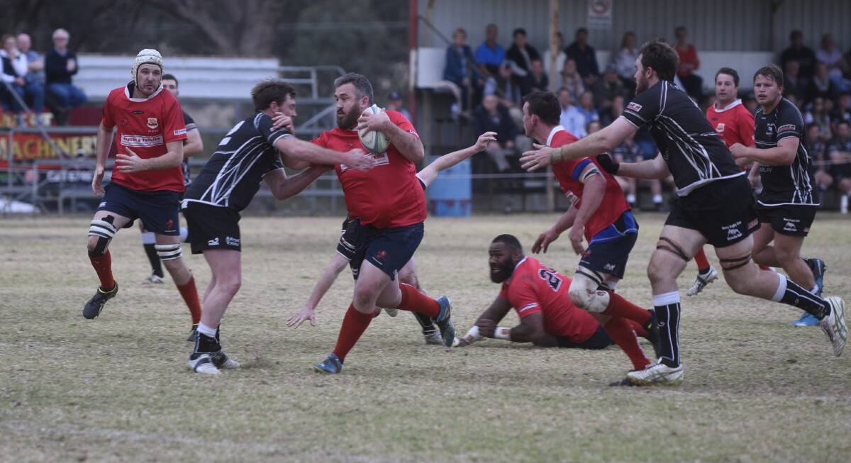 Out of my way: Gunnedah prop Isaac Scholes pushes off a Moree defender on his way to the tryline.