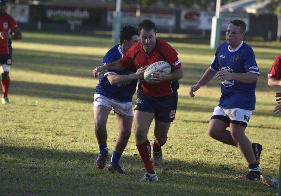 Jamie Mitchell brushes off the Scone defence en route to scoring the Red Devils' fourth try on Saturday. 