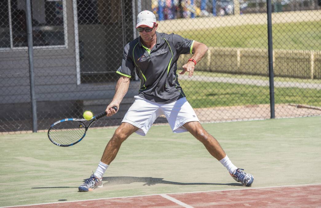 Winning shot: Craig Louis reaches for this forehand during his Division 1 men's singles quarter-final against Barry Wilson. Photo: Peter Hardin 160917PHB046