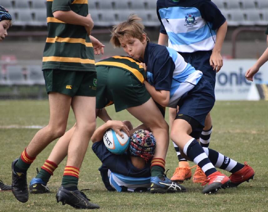 Strength: Playing for the NSW PSSA Invitational side Jack Pinn looks to clean this opposition player off the ball.