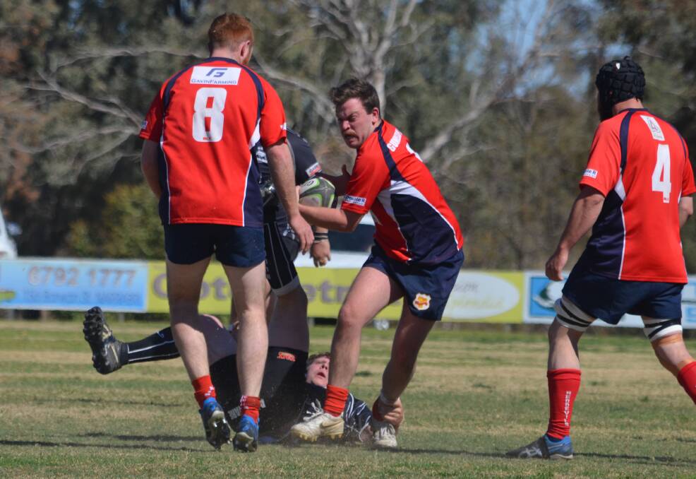 Gunnedah half-back Sandy Frend spins his way out of this attempted tackle.
