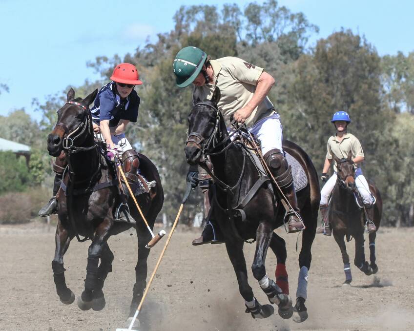 Carnival time: All is set for a big two days at the Gunnedah Polo Club grounds on the weekend when the club hosts their annual carnival. Here Harry Davidson playing for Carmyle hooks Gunnedah's Earl Herbert during last year's B grade runners-up final. 